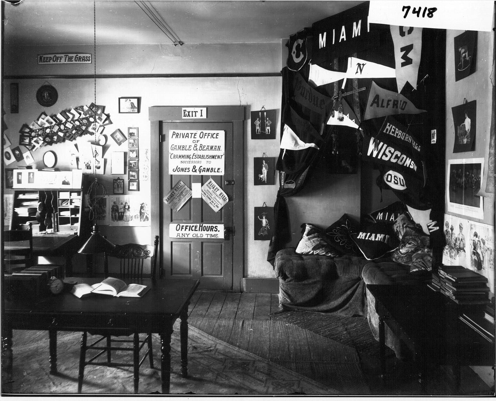 A 1906 dorm room decorated with college pennants