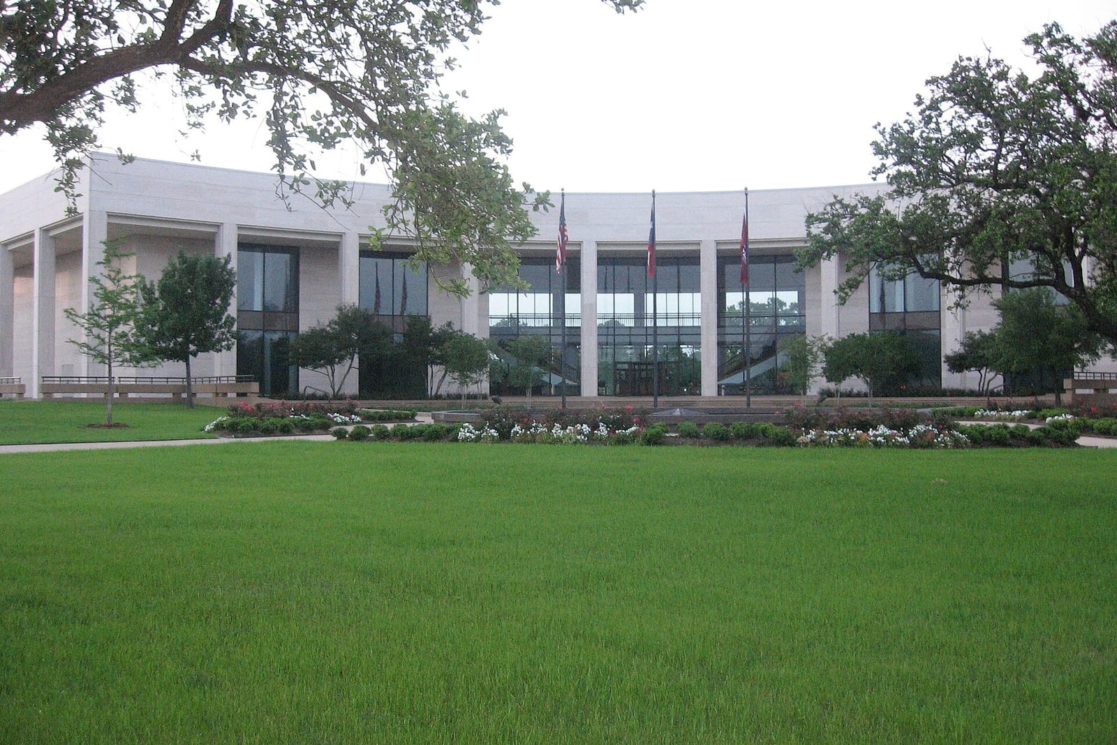 The Clayton W. Williams Jr. Alumni Center at Texas A&M across a green lawn